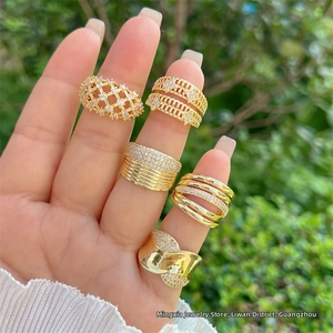 Close-up of 18K gold plated mesh rings with white zircon stones on woman hand