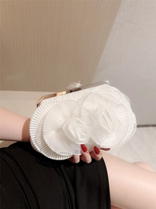 Elegant white ruffled wedding clutch bag with shimmering rhinestones and a metal frame