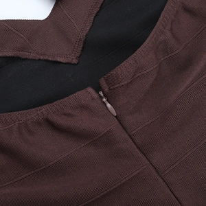 Close-up of invisible zipper and ribbed fabric on a dark brown knit bodycon maxi dress