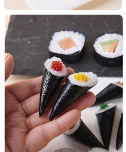 Close-up of realistic sushi hand roll models held in hand with high detail texture
