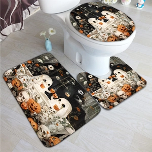 Detail of Halloween bathroom rug set featuring ghost and pumpkin patterns on soft fabric