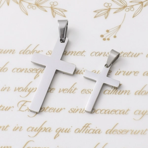 Detailed view of large and small polished stainless steel cross pendants for DIY necklaces