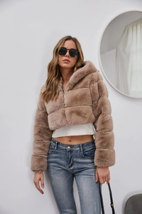 Detail of camel faux fur jacket texture with hood and front zipper closure