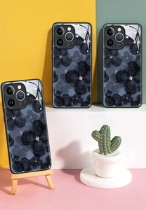 Close-up of ink flower patterns on glossy tempered glass phone cases for iPhone 16 Pro