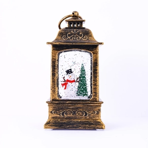 Detail of vintage bronze Christmas lantern with snowman and interior glittering snow scene