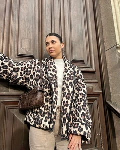 Detail of leopard print quilted jacket texture and casual open-front silhouette