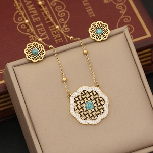 Golden floral hollow necklace set with turquoise center stones and white rhinestones