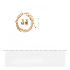 Macro view of the square amber rhinestone necklace and earring set in a gold finish