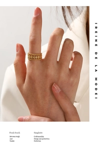 Detail of three-layer gold ring with olive leaf texture and beaded edges on model