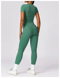 Back view of high-stretch forest green long sleeve yoga set showing body-sculpting fit