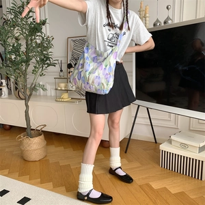 Detailed full body view of a large purple tulip canvas shoulder bag on a student outfit