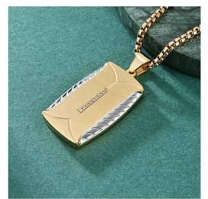 Close-up of gold and silver rectangle pendant necklace with small crystal stones