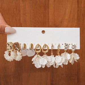 Detailed view of five-pair earring set featuring gold plating, pearls, and petal charms