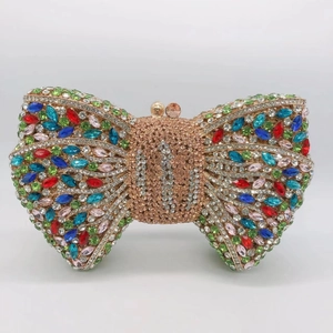 Detail shot of the colorful rhinestone bow clutch with a polished gold metal frame