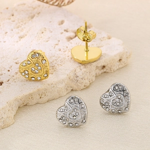 Macro shot of heart earrings with hollow engraving and micro-pave diamonds detail