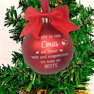 Red Christmas tree bauble with red bow and German text for grandmother on green branch
