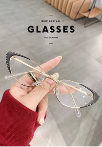 Detail shot of black and gold cat-eye metal glasses frame with size 51-18-142 marked