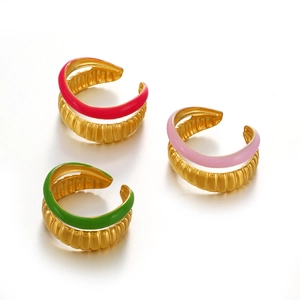 Golden wavy enamel rings in red, pink, and green colors on a clean white background
