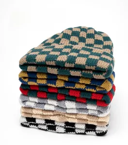 Detailed grid of thick checkered knit beanies in various colors for winter warmth
