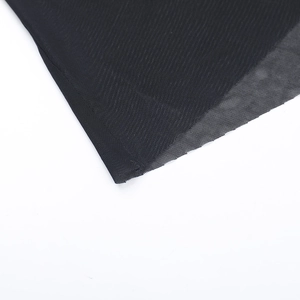Close-up of premium black mesh fabric texture and high-quality stitching on evening dress