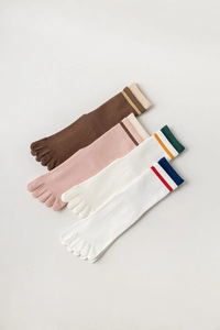 Detailed flat lay of four pairs of breathable cotton five-finger yoga socks in diverse colors