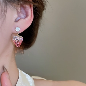 Detail of strawberry resin earring with zircon stud and pink glitter on model
