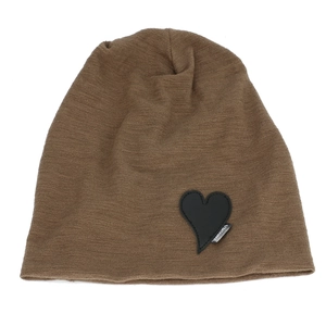Detailed view of dark brown knitted beanie with a black leather heart-shaped patch texture