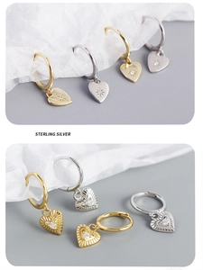 Detailed macro view of S925 sterling silver heart hoop earrings in gold and silver