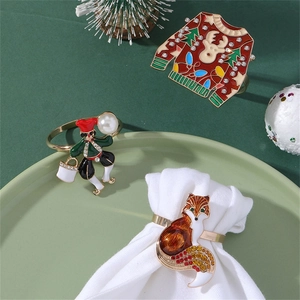 Detail of Christmas napkin rings featuring reindeer, elf, and fox designs with rhinestones