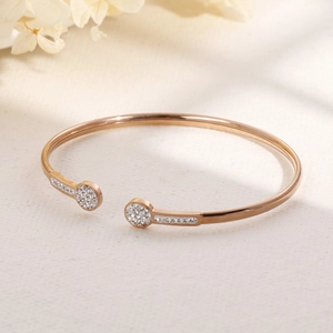 Close-up of rose gold open bangle with sparkling cubic zirconia pavé detailing on ends