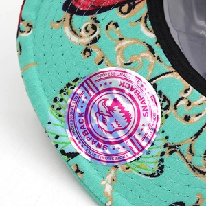 Detail of mint green snapback with golden baroque pattern and professional laser sticker