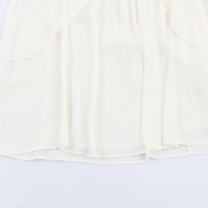 Elegant white layered ruffle hem shirt made of lightweight chiffon fabric in minimalist style