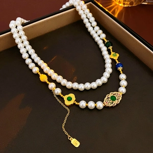 Detail of double-layer pearl necklace with colorful enamel lotus fan and Fu tag