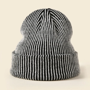 Close-up of the black and white striped knit texture and ribbed cuff on this winter beanie