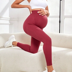 Seamless high-waisted maternity yoga pants in burgundy with stretch abdominal support