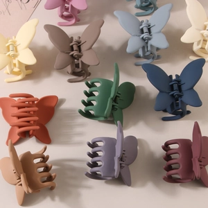 Matte butterfly hair claw clips in assorted pastel colors for elegant hairstyling