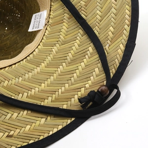 Detail of hand-woven paper straw sun hat with black fabric binding and adjustable chin strap