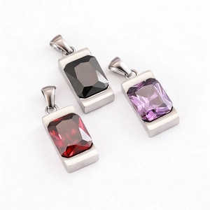 Macro shot of rectangular gem pendants in black purple and red colors on silver base
