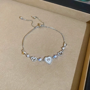 Detail of adjustable silver heart bracelet with sparkling zircon in a gift box