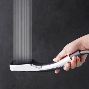 Chrome 300-hole pressurized hand shower head with fine water jets on a dark wall