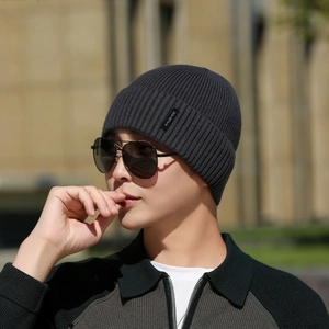 Mens dark grey knit beanie with ribbed texture and side label for winter warmth