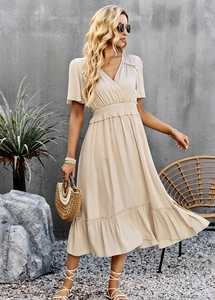 Detail of a beige V-neck midi dress with elastic waist and ruffle hem for a vacation look