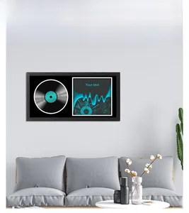 Modern wall-mounted black frame displaying a vinyl record and custom art in a living room