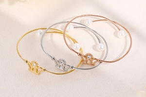 Detailed set of three crown pearl wire bangles in gold, silver and rose gold colors