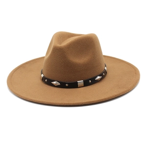 Detail of brown wool felt jazz hat featuring black leather band with silver metal studs