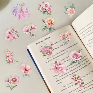 Detailed view of pink floral stickers applied on journal pages for artistic decoration