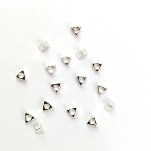 Scattered silver triangular metal beads with smooth finish for DIY jewelry making
