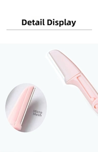 Macro view of the safety micro-mesh blade design on a folding pink eyebrow razor