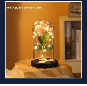 Detail of red preserved rose LED light with acrylic dome on natural wooden base