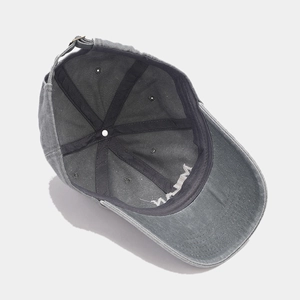 Detail of MILAN embroidered washed cotton baseball cap featuring adjustable metal buckle strap